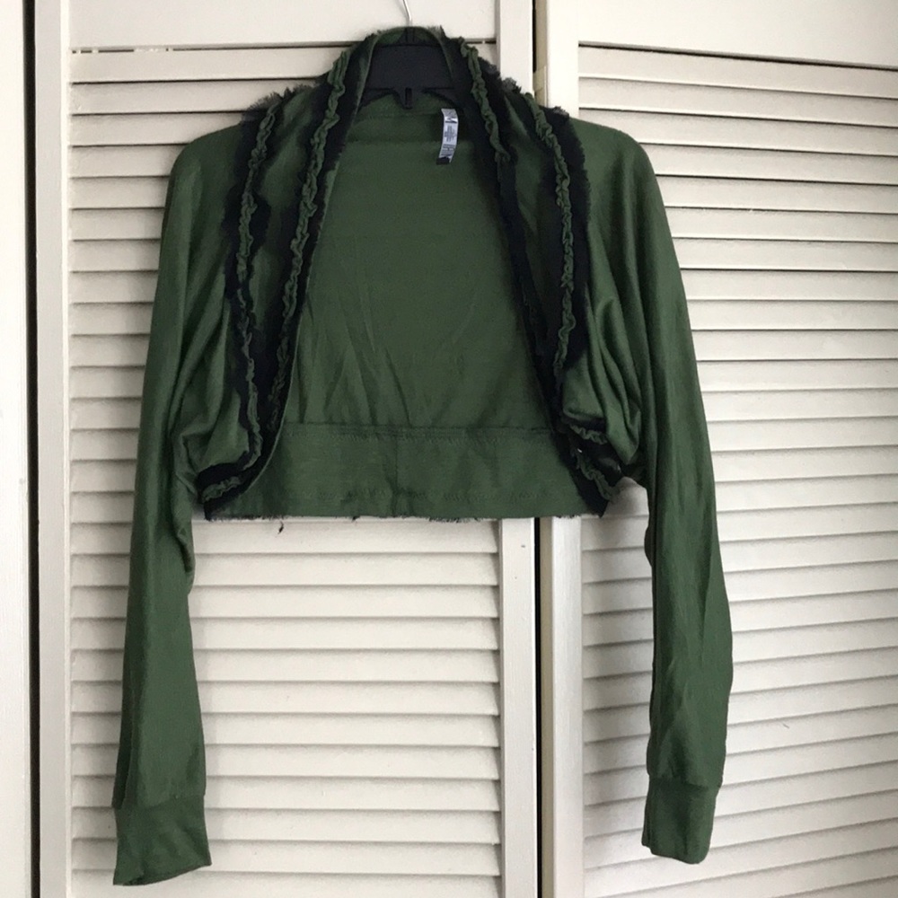 Green shrug with frilly black accents